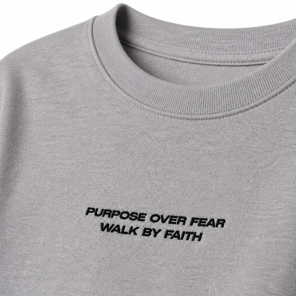 Close-up of embroidered on Purpose over Fear t-shirt