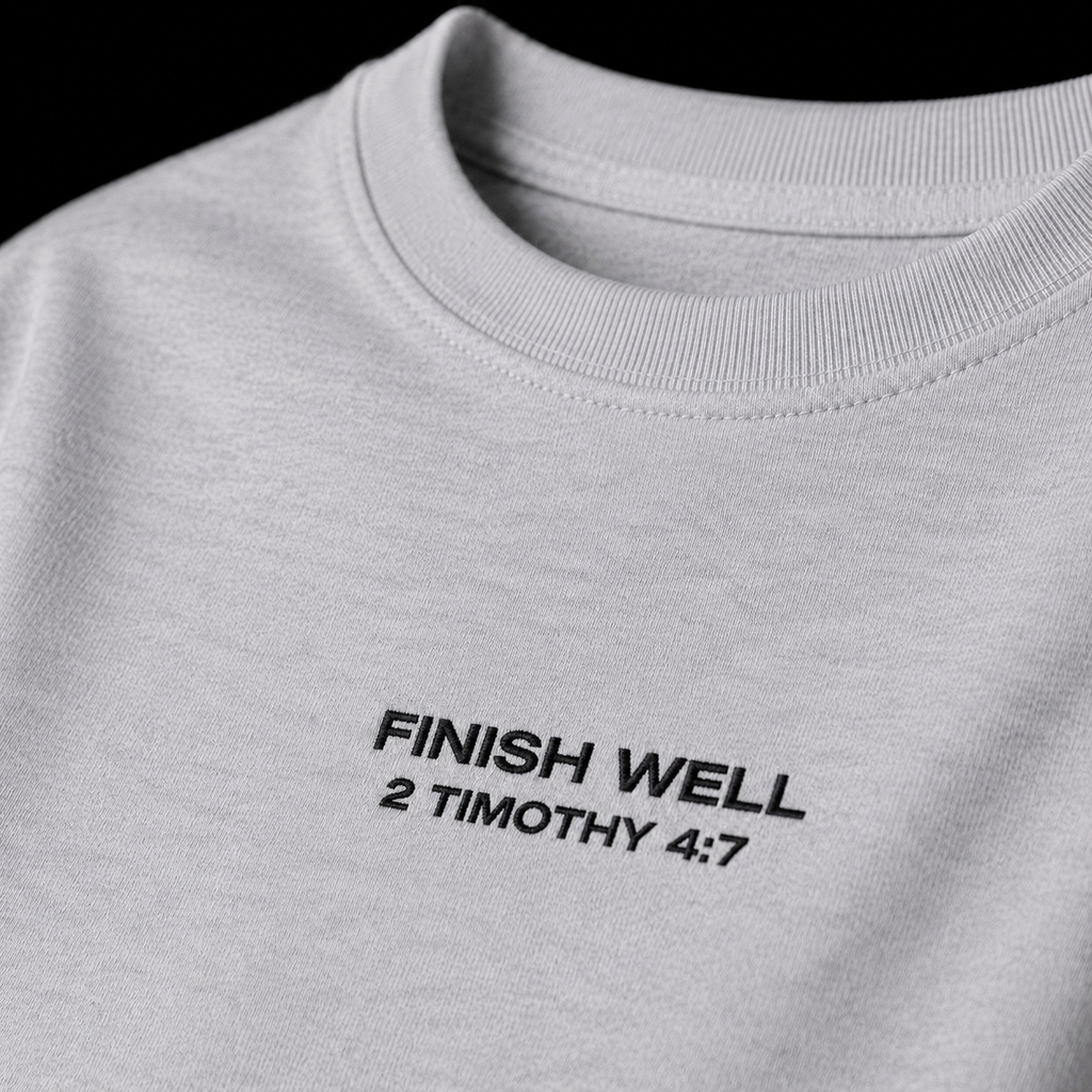 Close-up of embroidered on Finish Well t-shirt