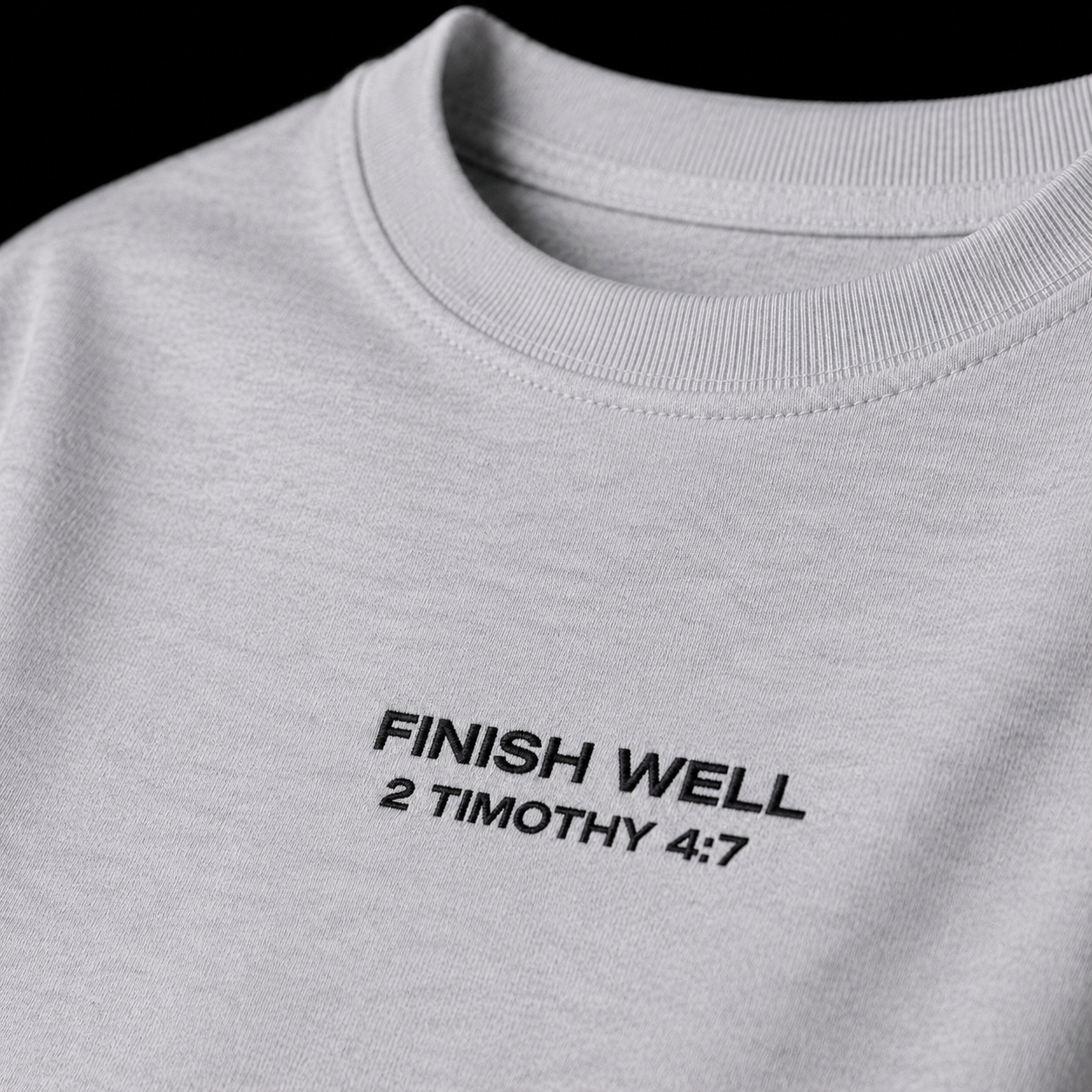 Close-up of embroidered on Finish Well t-shirt
